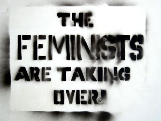 sign stencilled in spraypaint: 'The Feminists are Taking Over' | Tacky Harper's Cryptic Clues sign stencilled in spraypaint: 'The Feminists are Taking Over' | Tacky Harper's Cryptic Clues