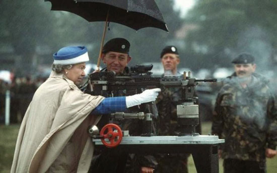 Queen Elizabeth II fires a machine gun while soldiers look on | Tacky Harper's Cryptic Clues Queen Elizabeth II fires a machine gun while soldiers look on | Tacky Harper's Cryptic Clues